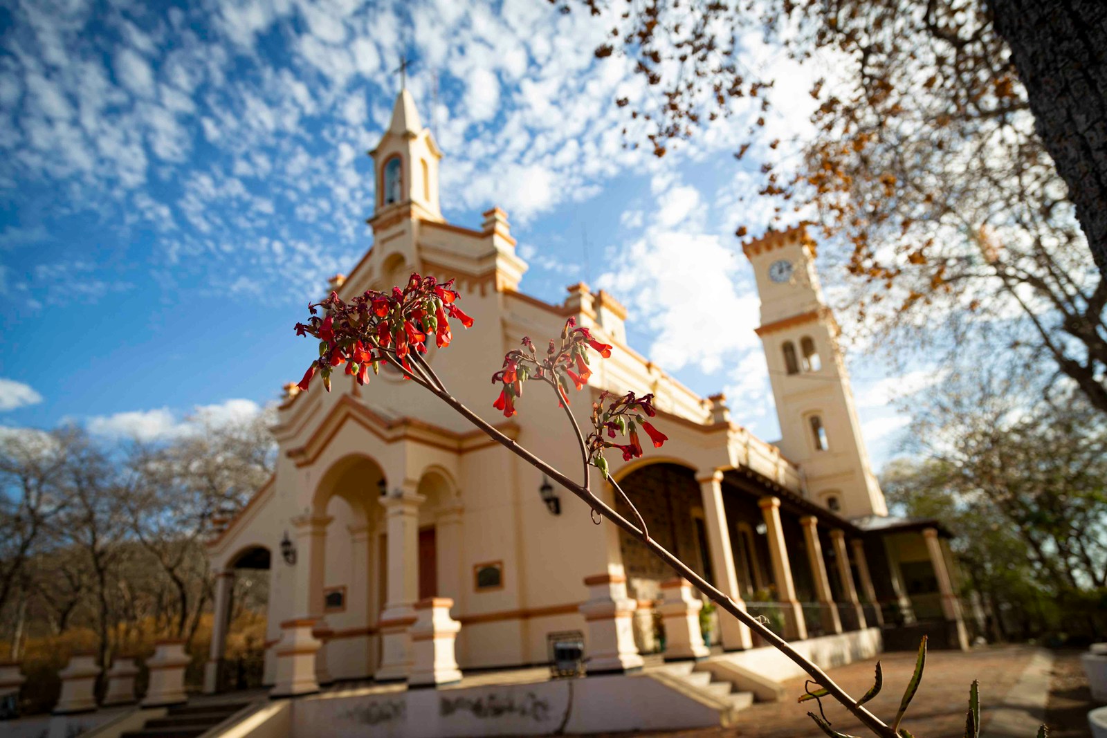 a white building with a tower and a cross on top